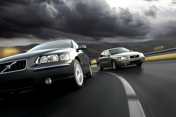 Moving Volvo cars and a stormy sky