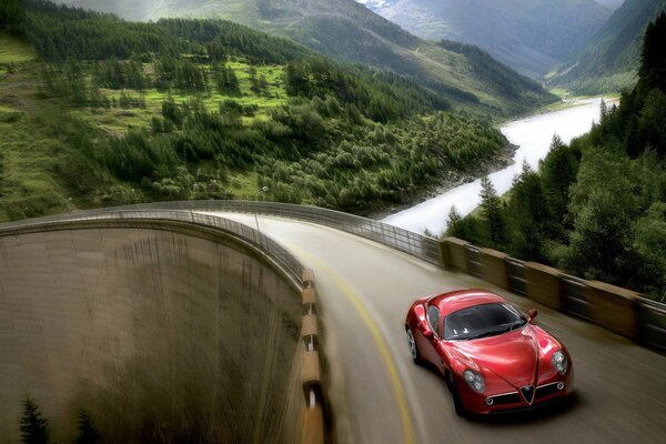 Red Alfa Romeo on platinum along the river