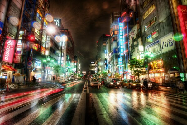 Cars and buildings along a night road in Tokyo Japan