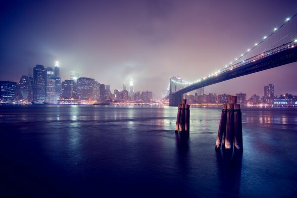 The night city on the river bank is like a holiday