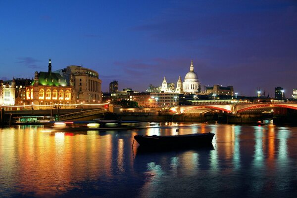 A boat on the river on a beautiful London night