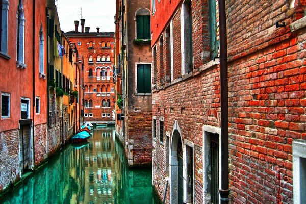 The dampness of the red houses on the canals of Venice