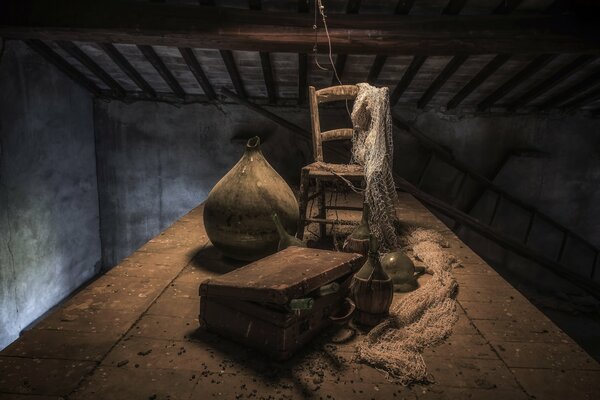 A chair with a net and a suitcase in the attic