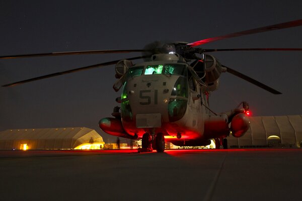 Illuminated helicopter at the base at night