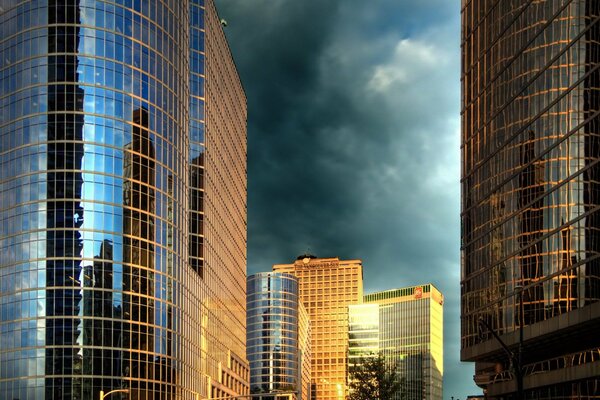 Blue clouds over piles of city glass