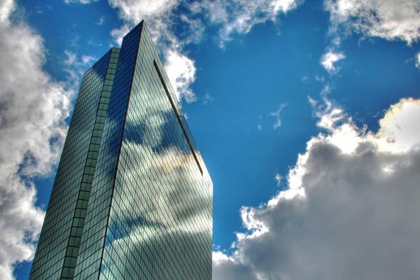 Gorgeous sky in clouds with a skyscraper