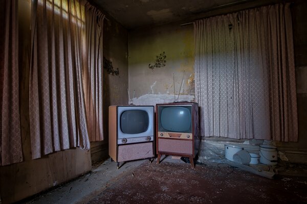 Two old TVs in the dark