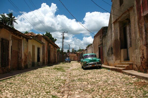 A street with old paving stones and retro cars