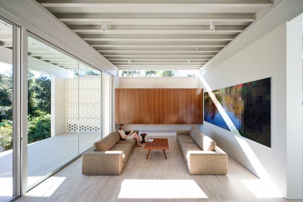 A room with comfortable sofas and paneled windows