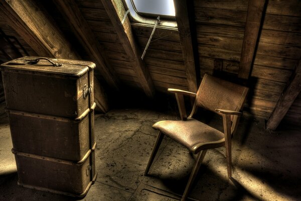 Suitcase on a chair in the attic in brown tones