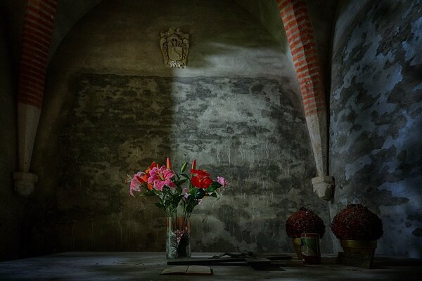 Bright flowers in a vase in a gray room