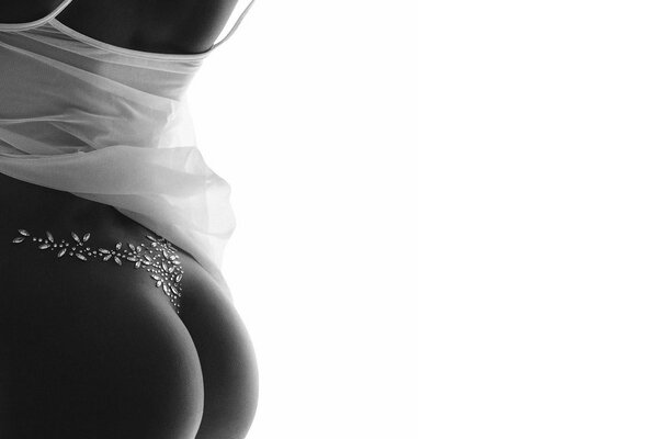 Black and white photo of buttocks in beautiful lingerie