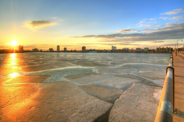 The bright sun reflects on the ice floes of the bridge