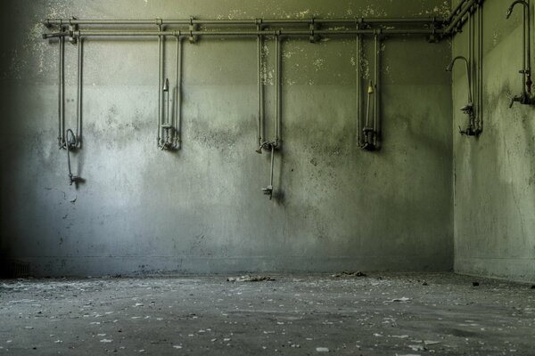 A shower room in a prison against the background of old walls