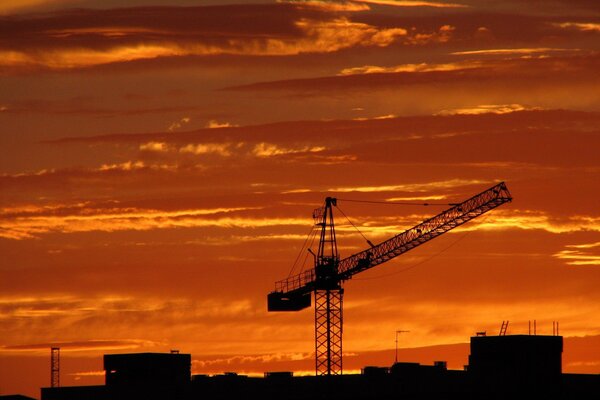 Crane at a construction site at sunset