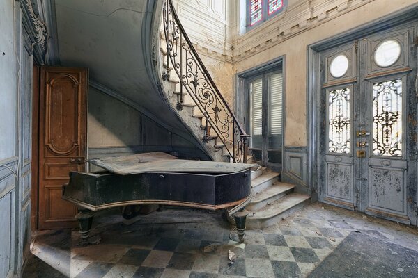 Piano under the stairs in a country house