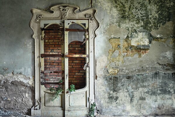 Beautiful white door with broken glass in an abandoned building