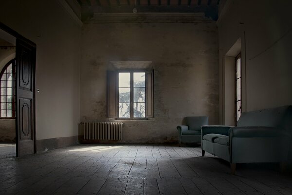 A room with a sofa by the window