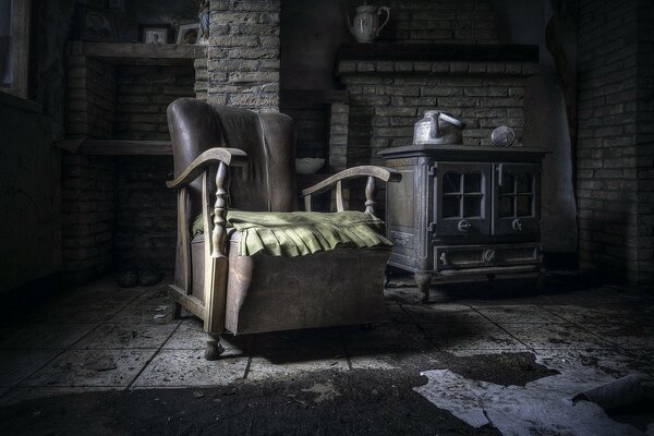 An empty chair and a kettle in an abandoned room