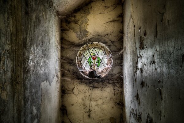 Stained glass window wrapped in cobwebs