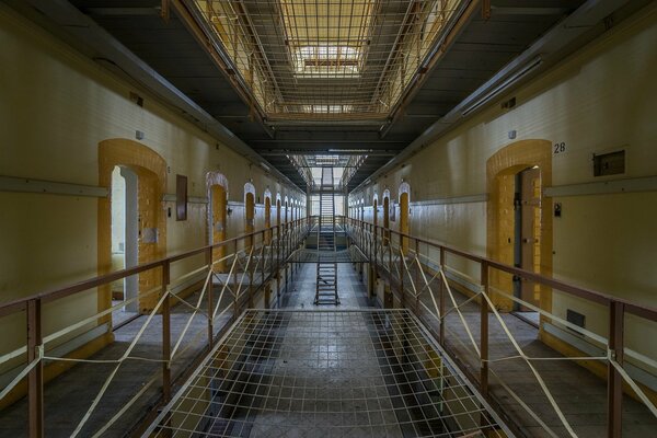 Corridor of prison cells with a grid