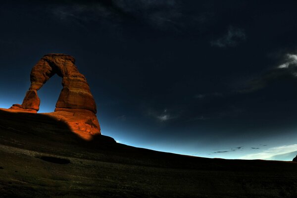 Sunrise in the night arch in the rock