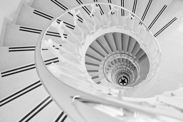 A white spiral staircase leading down