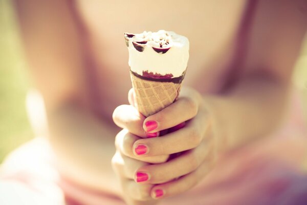 Bright summer. delicious ice cream held by mom s hands