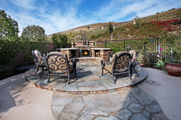 Design of a summer courtyard with a fireplace