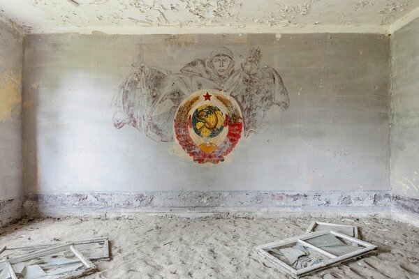 An abandoned room with a coat of arms