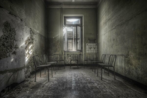 Seven rusty chairs in the room