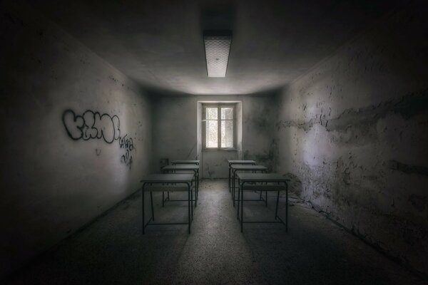 A gray room with tables and a window