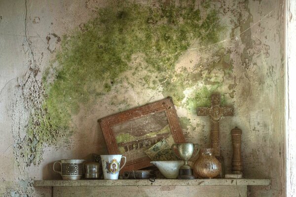 A cup on the background of a peeling wall