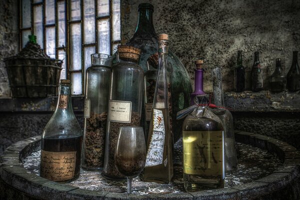 A strange dark room with a window and bottles