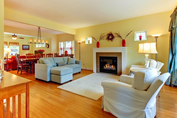 A warm-toned room with snow-white furniture and a fireplace