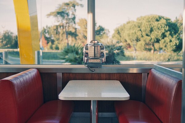 There is a diner with large windows in the park