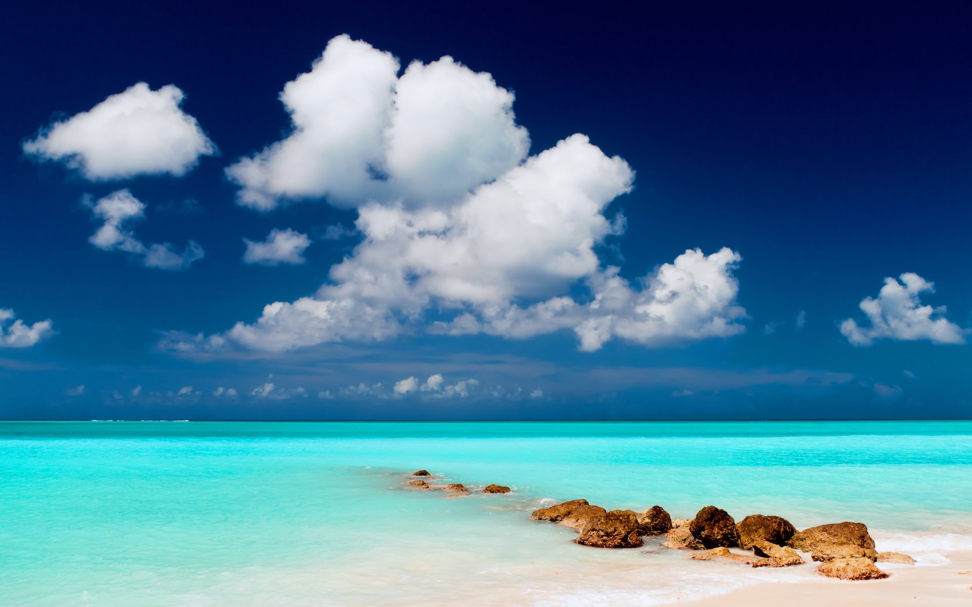 paisaje agua piedras playa cielo nubes arena mar