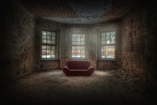 A lonely pink sofa in the dark