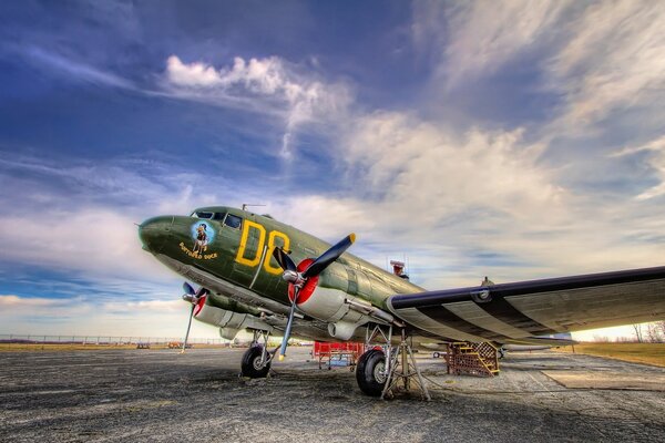 Airplane on the background of a beautiful sky with clouds