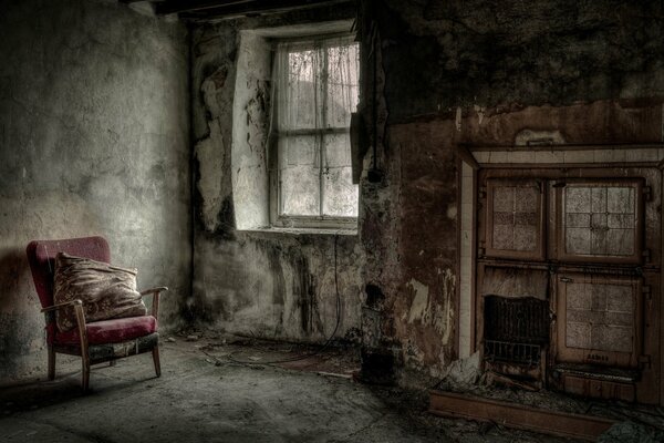 The interior of an abandoned room with a fireplace