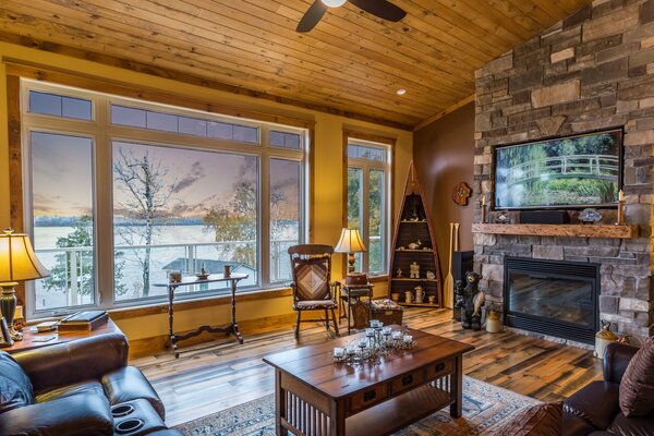 Design of a living room with a fireplace by the window