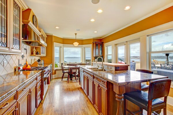 The interior of a wooden kitchen with a stone countertop