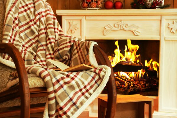 Rocking chair with a cozy blanket by the fireplace