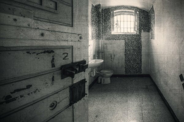 The interior of a prison cell. black and white
