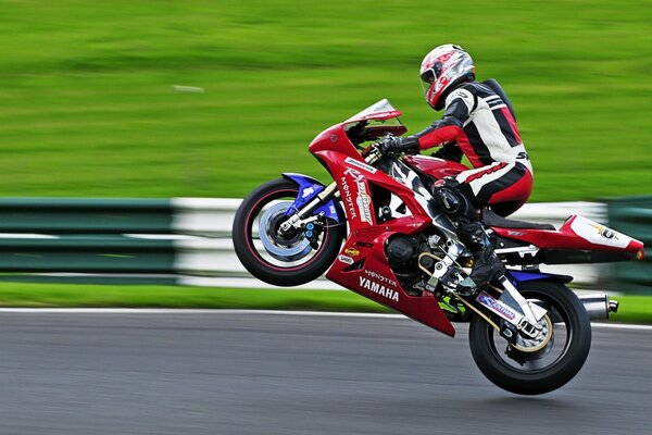 A sports motorcycle is carried on the rear wheel