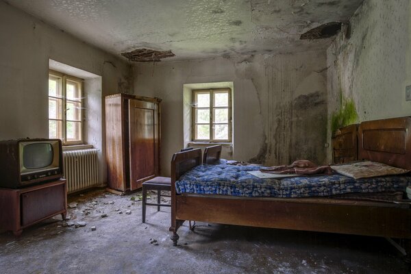 An abandoned bedroom with old furniture