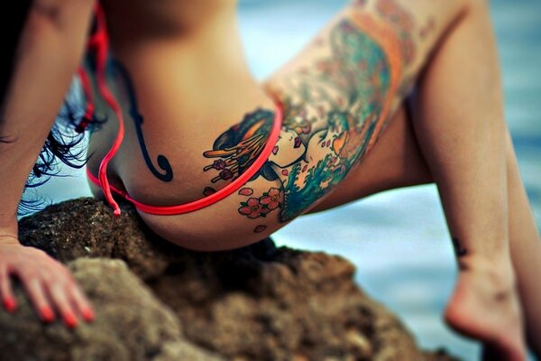 A girl with a tattoo on a beautiful leg