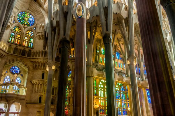 Gothic columns and bright stained glass windows in the Sagrada Familia Church in Barcelona in Spain