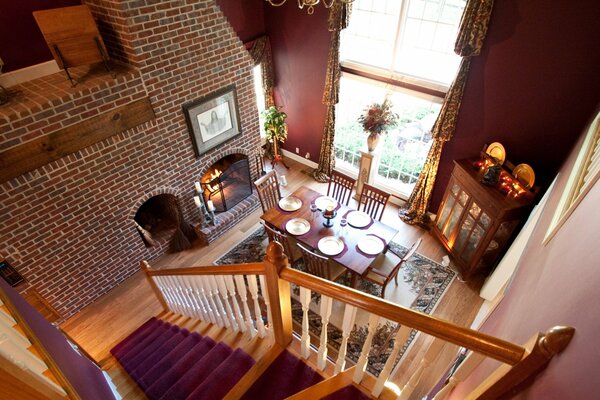 Interior of the dining room with fireplace and staircase