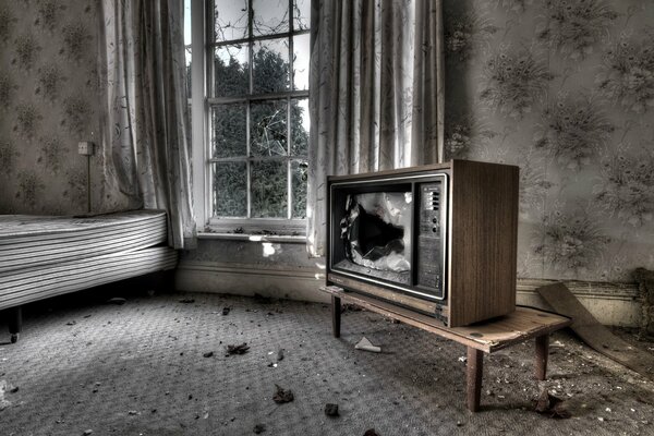 Zerbrochener alter Fernseher im Zimmer